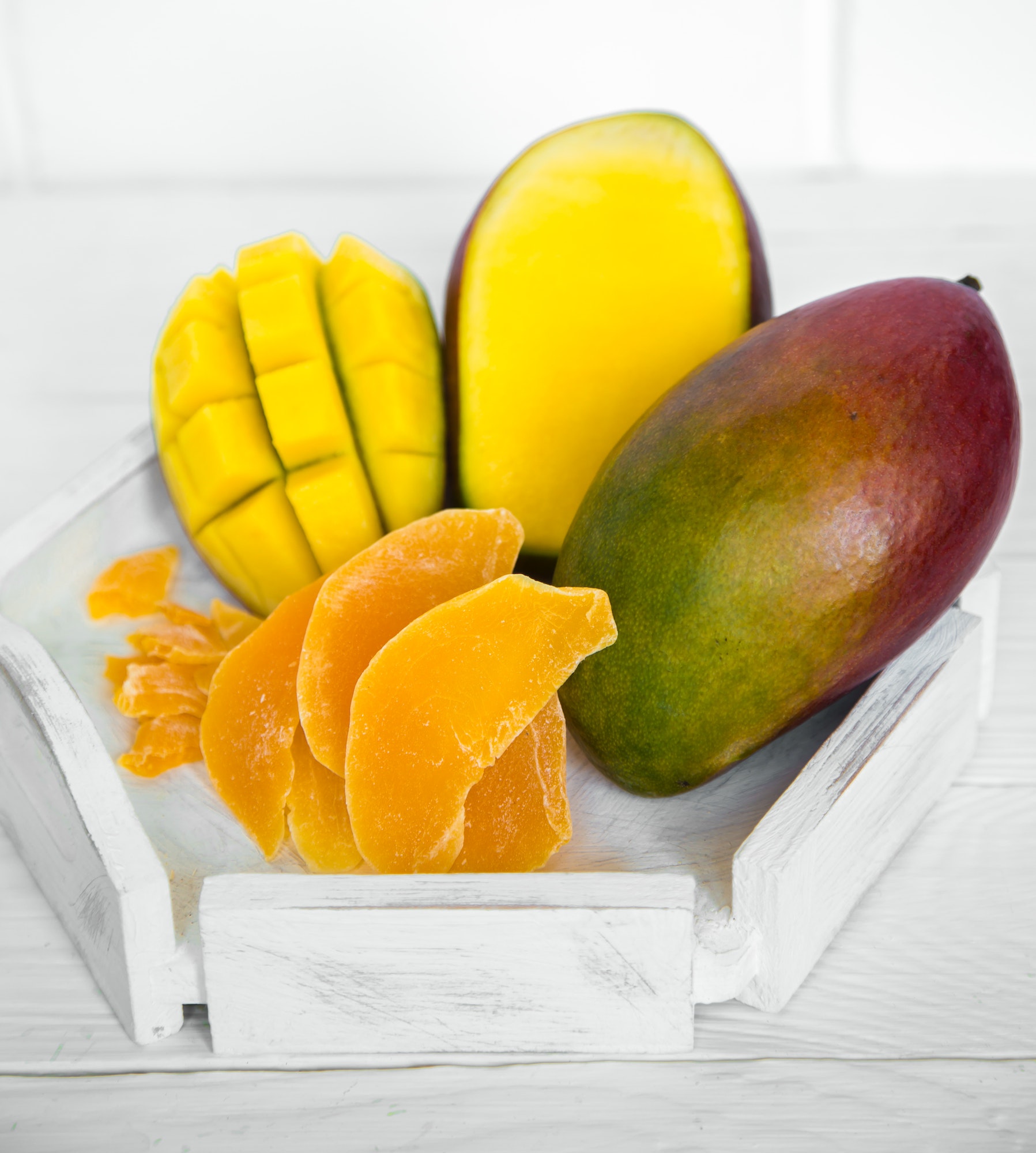 Mango on a white wooden background with juice